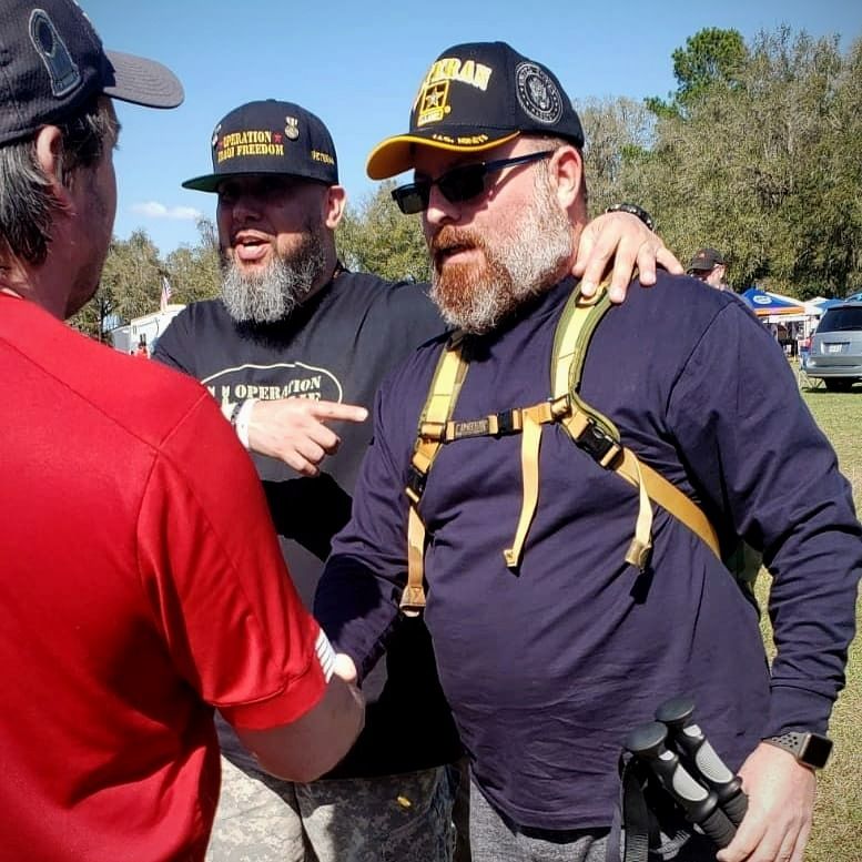 Two O11C members sharing a moment at an outdoor event
